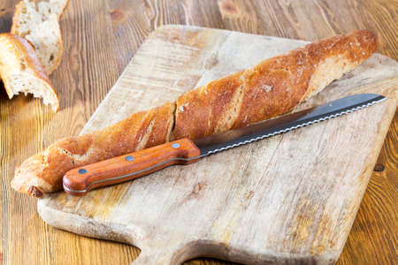 long fresh flavored bread with a crisp crust and soft fresh flesh, food close upの写真素材