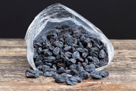 Packed in a cellophane bag, dried large raisins made from grapesの写真素材