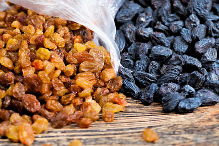 Packed in a cellophane bag, dried large raisins made from grapesの写真素材