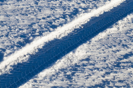 winter road with ruts from cars in winter, covered with snow after snowfall, ruts from cars on the...