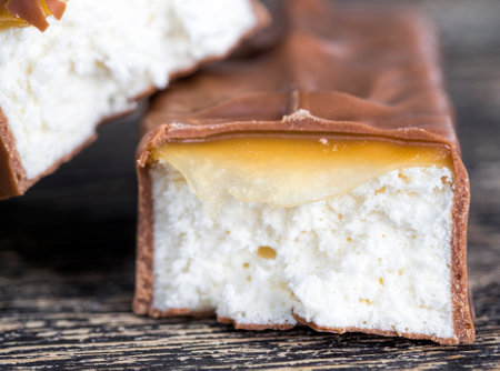 delicious and sweet chocolate made from cocoa and sugar, details and closeup of products made from cocoa and white fillingの写真素材