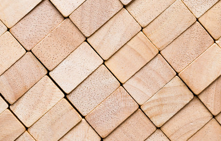 cubes made of bamboo wood, closeup of wooden cubes that make an uneven surface in the form of...