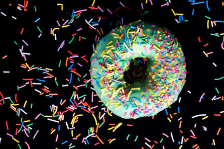 delicious and fresh green donut with fruit flavor and filling, closeup of a food product with a large number of caloriesの写真素材