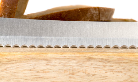sharp toothed knife on the cutting board where bread is cut