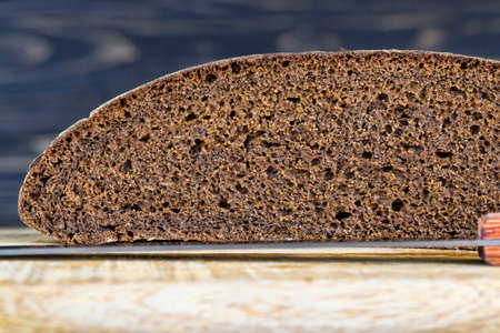 structure of dark rye bread freshly cut into pieces, close-up at home, the structure and texture of a loaf of bread from the insideの写真素材