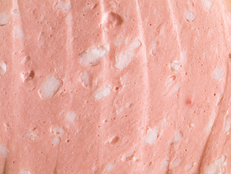 sliced pink boiled sausage with pieces of lard found in meat productsの写真素材