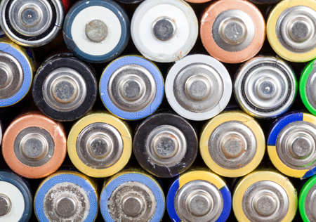 a bunch of old batteries in dirt and oxidation after use, the background of the batteries with the side where the plusの写真素材