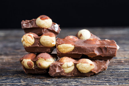 sweet milk chocolate with roasted hazelnuts, close-up of sweets and desserts