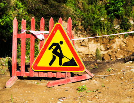 old road sign on the repair work on the construction site, close-up of dirty signの写真素材