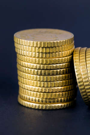 stacked a large number of European coins at fifty cents, close-up of the Golden coins of the European Unionの写真素材