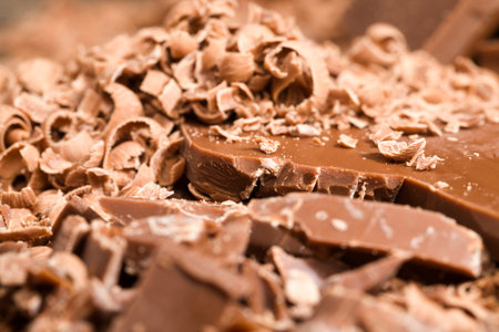 sliced and broken crumbs delicious milk chocolate in the middle of cooking desserts, sweets details