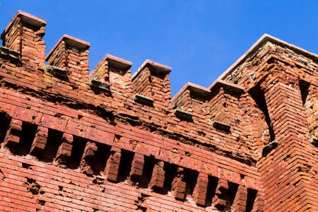 partially destroyed ancient brick wall of the fortress, made of red brick, photo close-upの写真素材