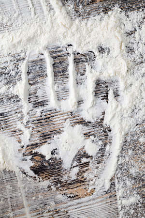 traces of the child hand on a large amount of flour after cooking real wheat pasta, fingerprints and palmsの写真素材