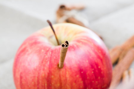 red ripe and juicy Apple with cinnamon sticks, making a delicious dessert of fruits and spices