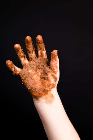 real milk chocolate and a baby that is completely smeared in melted milk chocolateの写真素材