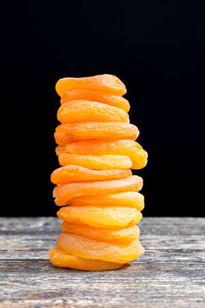 beautiful orange color small dry apricots traditional food in Eastern countries, close-up of dried fruits beautiful color due to the use of chemical additivesの写真素材