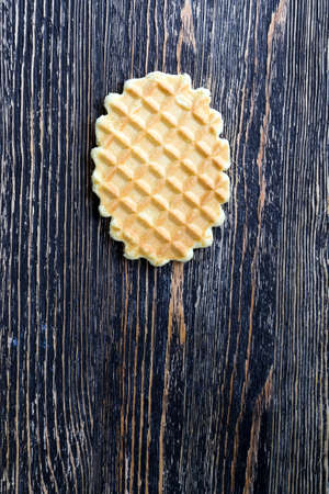 one lying on the wooden surface of wheat sweet waffles, close-up of sweets used as a dessert, topの写真素材