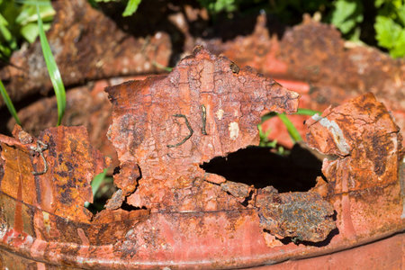 part of the old metal surface covered with orange and yellow rust and corrosion