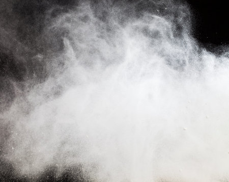 flying on the background of black white wheat flour during the preparation of products
