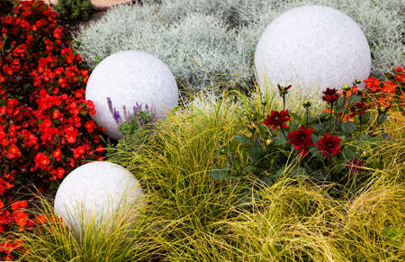 large stone balls on flower beds for decoration, close up in a Park for recreationの写真素材