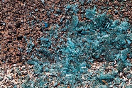 Broken glass from a car on the asphalt after an accident committed with a car, glass from a car