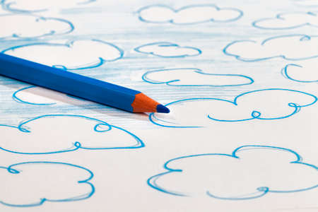 blue clouds drawn with a blue pencil on ordinary paper of poor quality, Amateur drawing closeupの写真素材