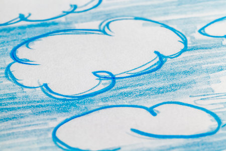 blue clouds drawn with a blue pencil on ordinary paper of poor quality, close-up of homemade Amateur...