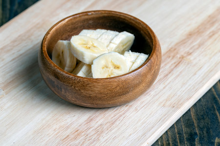 sliced ripe banana on a wooden boardの写真素材