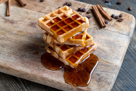 soft waffles with natural bee honey on a serving board, cooking with soft sweet waffles and bee honeyの写真素材