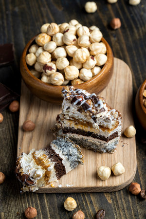 multi-layer cake with different layers, caramel, poppy seeds and cream layers of cake for dessert with nutsの写真素材