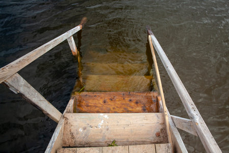 an old wooden staircase on the pier, an old rotting wooden staircase leading to the lakeの写真素材