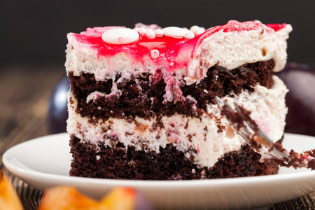 delicious chocolate milk cake made of several sweet layers, sweet layered cake with cherry flavor
