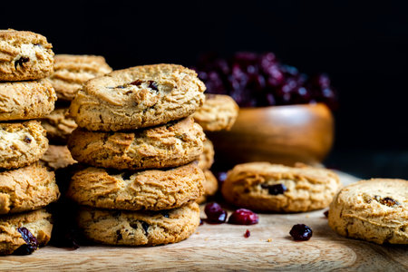 round wheat cookies with dried cranberries, delicious dried cookies made of high-quality flour with dried red cranberries on the tableの写真素材