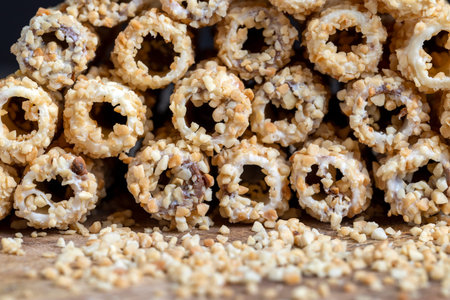 waffle tube with chocolate filling and crushed peanuts, sweet waffle tubes with fried pieces of...