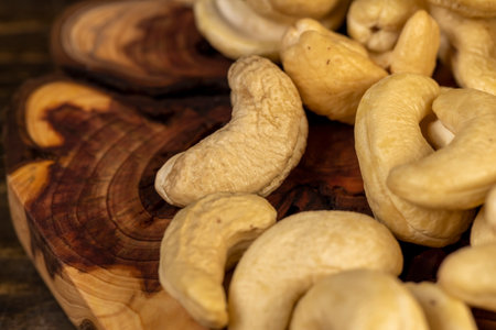 cashew are scattered on a board, cashew nuts are healthy and allowed for vegans. closeupの写真素材