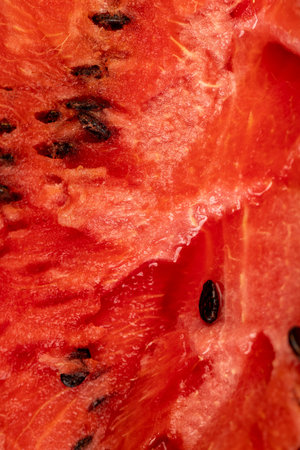 red watermelon pulp with black seeds, sweet ripe watermelon cut into halves