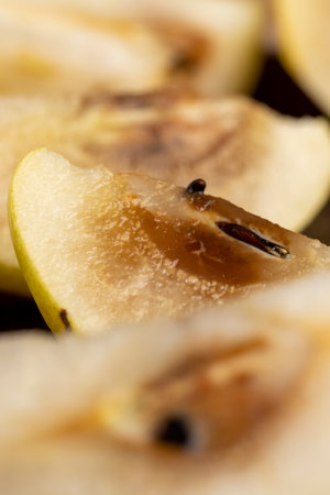 the pulp of pear inside of which has begun to rot, rotted inside of a ripe pear from long-term storage, close upの写真素材