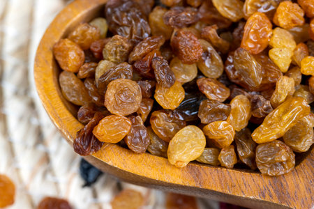 dried yellow raisins on the table, yellow dry raisins for cooking dessertsの写真素材
