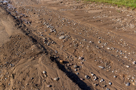 A road in the countryside after rain, landslides on a country road after heavy rains and rains in summerの写真素材