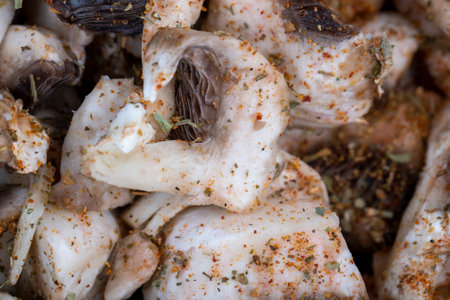 sliced white mushrooms during cooking, cooking with vegetable ingredientsの写真素材