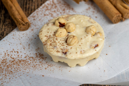 homemade white chocolate with cinnamon and nuts, soft delicious and sweet white chocolate and hazelnutsの写真素材