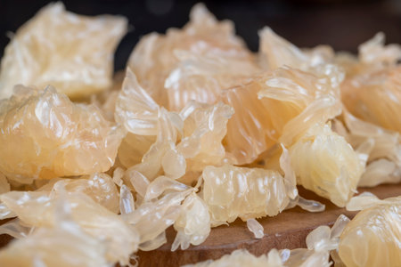 Freshly peeled pink pomelo on the table, sweet fresh citrus pomeloの写真素材