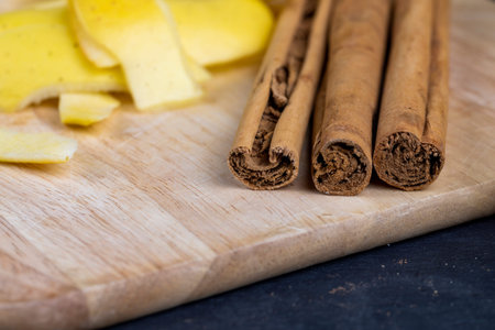 Sticks of real cinnamon on a board with apples, sliced apples and fragrant cinnamon on the table