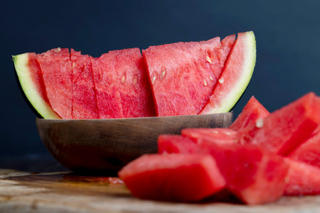 Ripe red watermelon cut into pieces with black seeds, slices of sweet red watermelonの写真素材