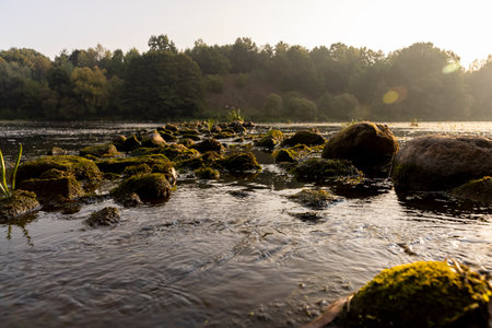 The river during the dawn in autumn, the waves on the river during the sunrise of the sun in the autumn seasonの写真素材