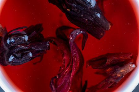 red flower tea from red rose petals, delicious red tea from rose buds on the tableの写真素材