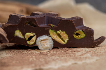 homemade black chocolate with cinnamon and nuts, soft dark dark chocolate and hazelnuts and...