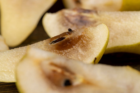 ripe green pear, the pulp inside of which has begun to rot, part of the rotted inside of a ripe...