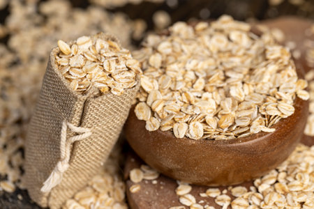 a bag with oatmeal flakes for making porridge, dry cereal flakes from oats, flattened, steamed and dried, closeupの写真素材