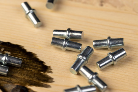 rivets to install shelves in cabinets, furniture metal fittings on a wooden board